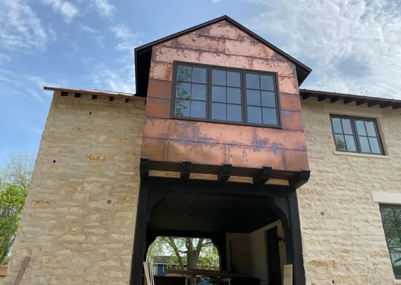 Copper metal panel facade on a stone building for Metal Roof Coating in Barrington
